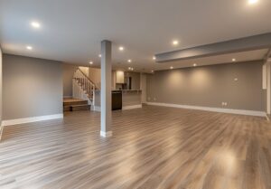 Large open-concept basement renovation with polished wood floors and modern lighting.