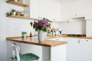 Modern small kitchen remodel with light colors and open shelving.