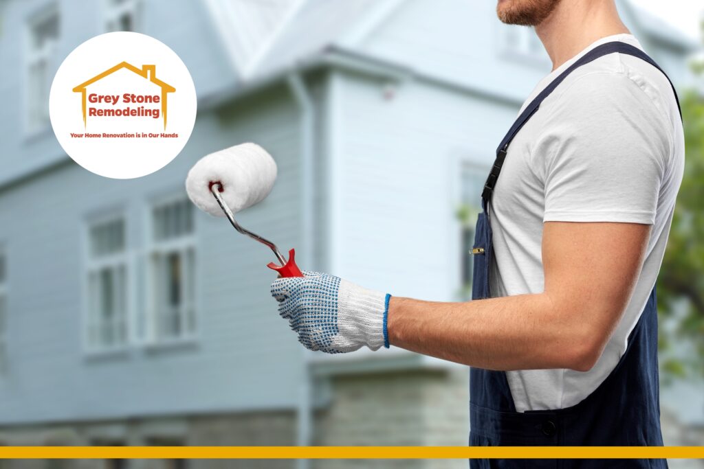Professional painter with roller brush ready to start exterior painting — the right painting company for quality results.