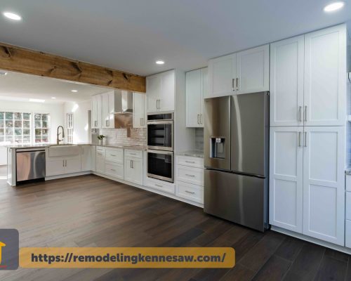 Modern kitchen renovation with custom white cabinets, stainless steel appliances, and exposed wooden beam in Marietta